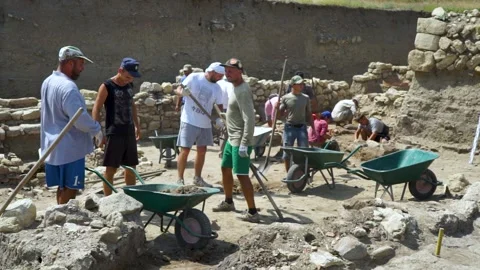 Archaeologists, Worker digging with a shovel at an archaeological site Vídeos de archivo 159755520