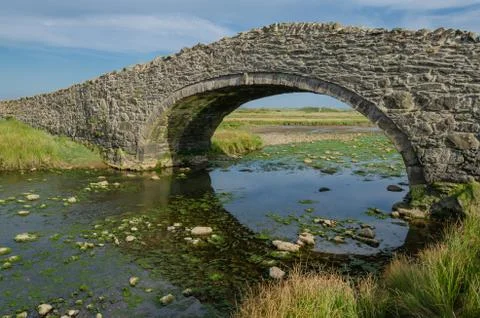 The arched Aberffraw Bridge in Anglesey Stock Photos