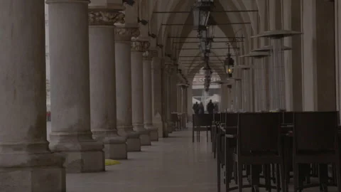 Arched arcade with historic columns and hanging lantern lamps Stock Footage 342558467