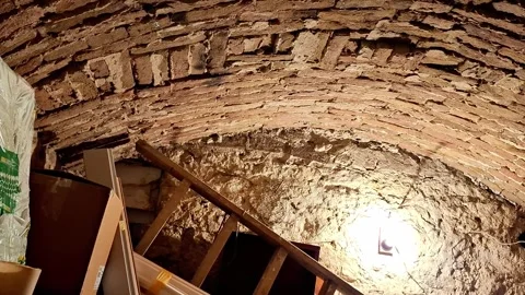 Arched  Ceiling and Stone Walls of Rustic Cellar Illuminated by Bright Light Stock Footage 332322782
