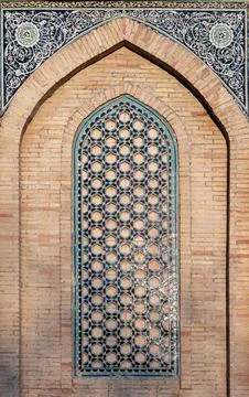 Arched geometric tile window of an ancient Mosque Stock Photos