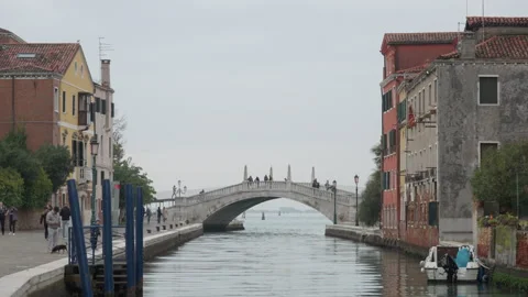 Arched stone bridge over a quiet canal in residential Venice district Stock Footage 325778183