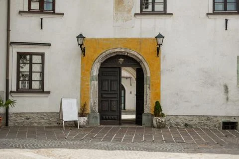 An arched stone tunnel frames a view of a white historic building with brown 写真素材