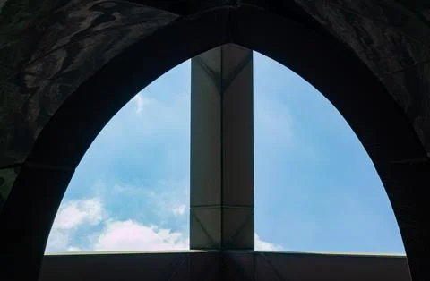 Arched tent frame frames blue sky with clouds. Stock Photos