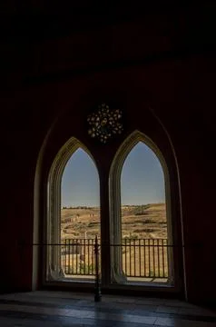 Arched upper windows where the natural landscape outside can be observed Stock Photos
