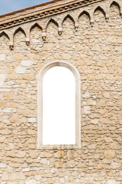Arched window in the ancient stone wall white isolated 库存照片