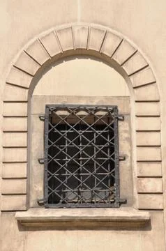 Arched window with iron grid Foto stock
