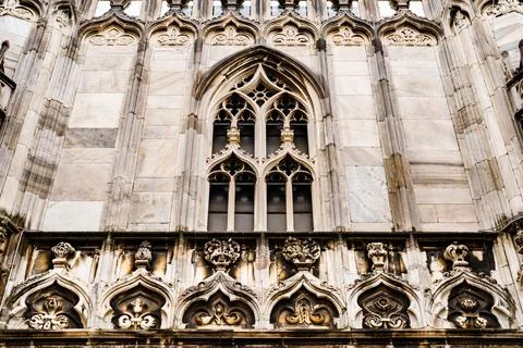 Arched window with marble frame on the facade of the Duomo. Italy, Milan Stock Photos