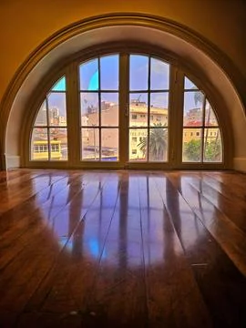 Arched window overlooking the cityscape Stock Photos