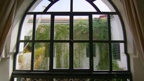 Arched Window Overlooking Green Courtyard in Traditional Marrakesh Riad, Morocco Stock Footage 342030773