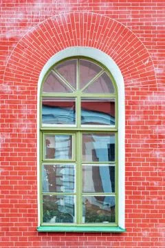 Arched window on red. Фото
