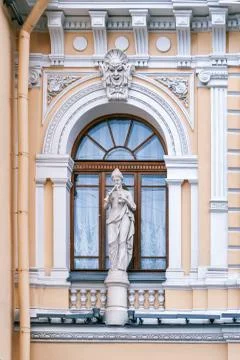 Arched window with a statue. Stock Photos