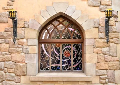 Arched window in stone wall Stock Photos