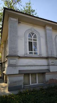 Arched window on white building with classical pilasters. Fotos Stock