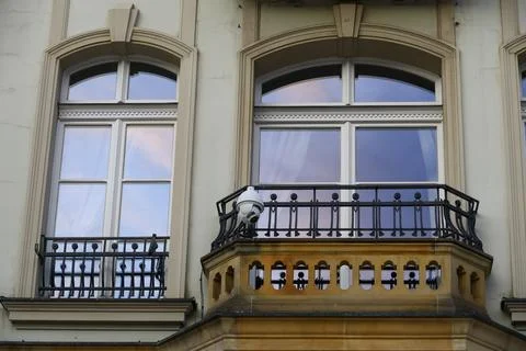 Arched windows with balcony and security camera Fotos Stock