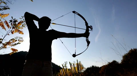 Archer drawing his compound bow silhouette Stock Footage 68310915