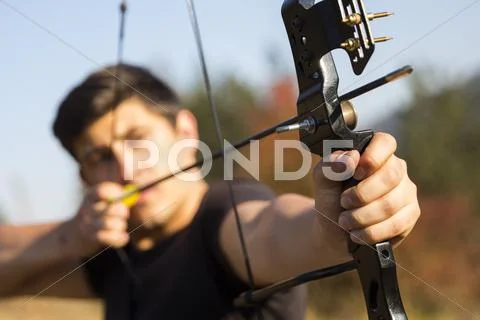 Archer drawing his compound bow Stock Photos