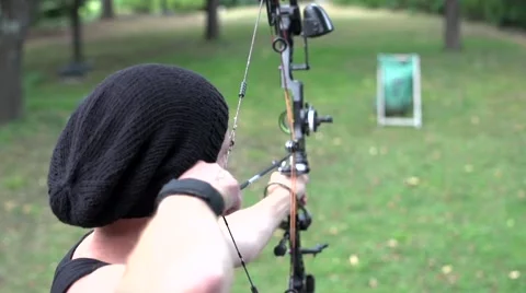 Archer dressed in black shooting on sight disc, close. Stock Footage 53857793