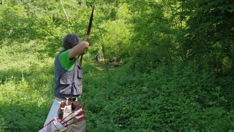 Archer in the forest, back view Stock Photos