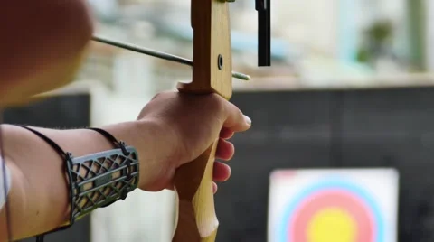 Archer holds his bow aiming at a target Stockbeeldmateriaal 64623554