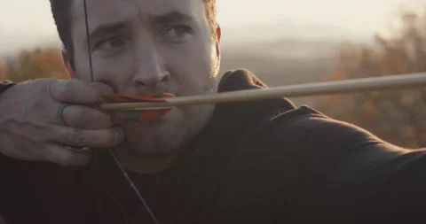 Archer man draw or pull a bow shoot or release arrow extreme close up 動画素材 147398527