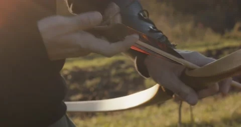Archer man take arrow nock attach on bow pull aim shoot closeup flare 動画素材 147398598