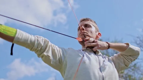 Archer pull back the string and shoots arrow Stock Footage 100558840