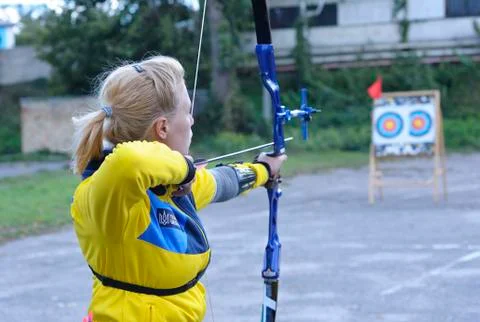 Archer pulling the string back of bow and arrow, tra Foto stock