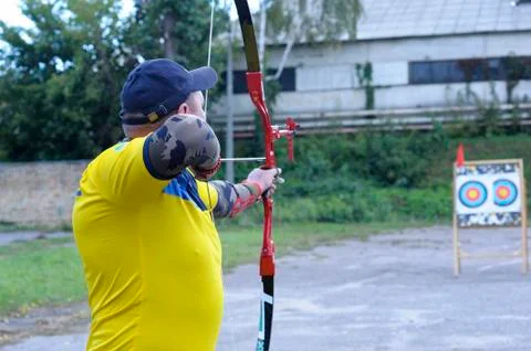 Archer pulling the string back of bow and arrow, tra 写真素材