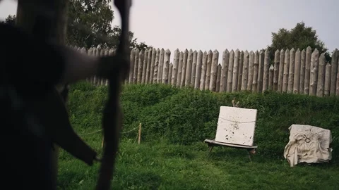 The archer shoots an arrow towards the target and hits it Stock Footage 258452031