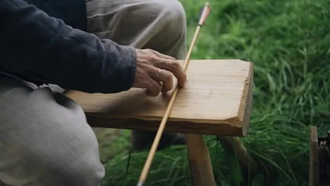 The archer takes the arrow lying in front of him to make a shot Vídeo Stock 258452069