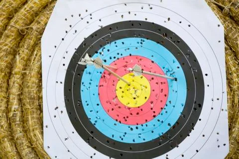Archery Target With Arrows On a straw background Stock Photos