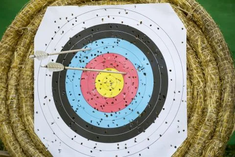 Archery Target With Arrows On a straw background Stock Photos