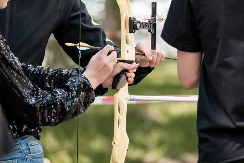 Archery Training Session with Instructor: Close-Up of Nocking Arrow on Bow,.. Stock Photos