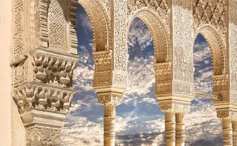 Arches in Islamic style (against the clouds) in Alhambra, Granada, Spain 写真素材