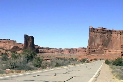 Arches National Park minivan driving toward Stock Footage