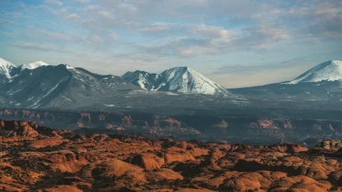 Arches National Park time lapse. Red rock formations and snow capped La Sal Stock Footage 346549804