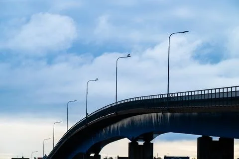 Arching bridge connecting islands Stock Photos