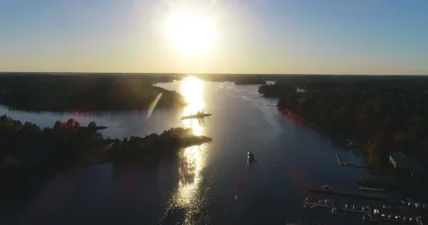 Archipelago sunset, C4k aerial view a boat leaving a harbor in tammisaari saa Stock Footage 89953441