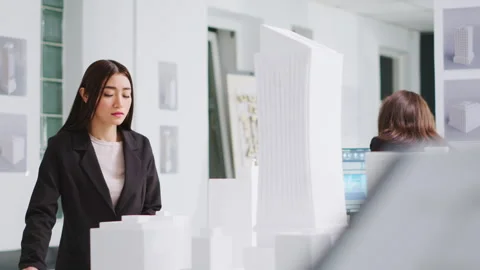 Architect analyzing blueprints and 3d building models Vídeos de archivo 262995680