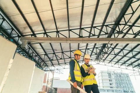 Architect and Builder with computer laptop discussion planning on progress to Stock Photos