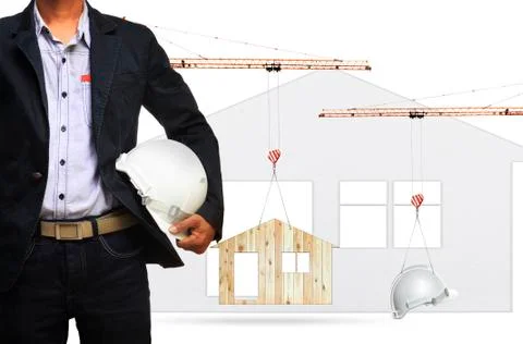 Architect and construction crane lifting home and safety helmet on white back 写真素材