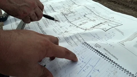 An architect and a construction engineer check the building plan of the building Stock Footage 109616694