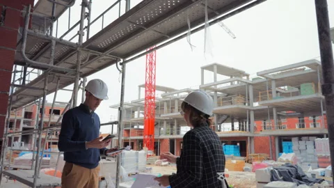 Architect and construction manager analyz building project plans and docume.. Stock Footage 329640798