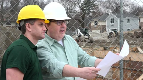 Architect and Construction Worker looking over plans on site Stock Footage 49087087