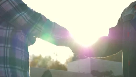 Architect and construction worker shaking hands at sunset on building site Video stock 315409072