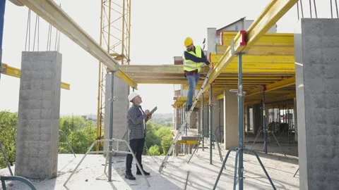 Architect and construction worker supervising building site Stock Footage 343449511