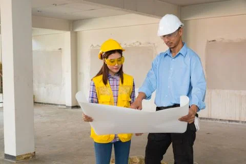 Architect and Constructor Discussion on Building Project Inspection with Ar.. Stock Photos