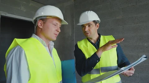 Architect and contractor discussing plans on construction site Stock Footage 160599573