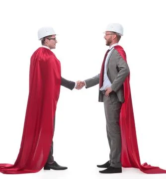 Architect and developer in capes super heroes shaking hands Foto stock
